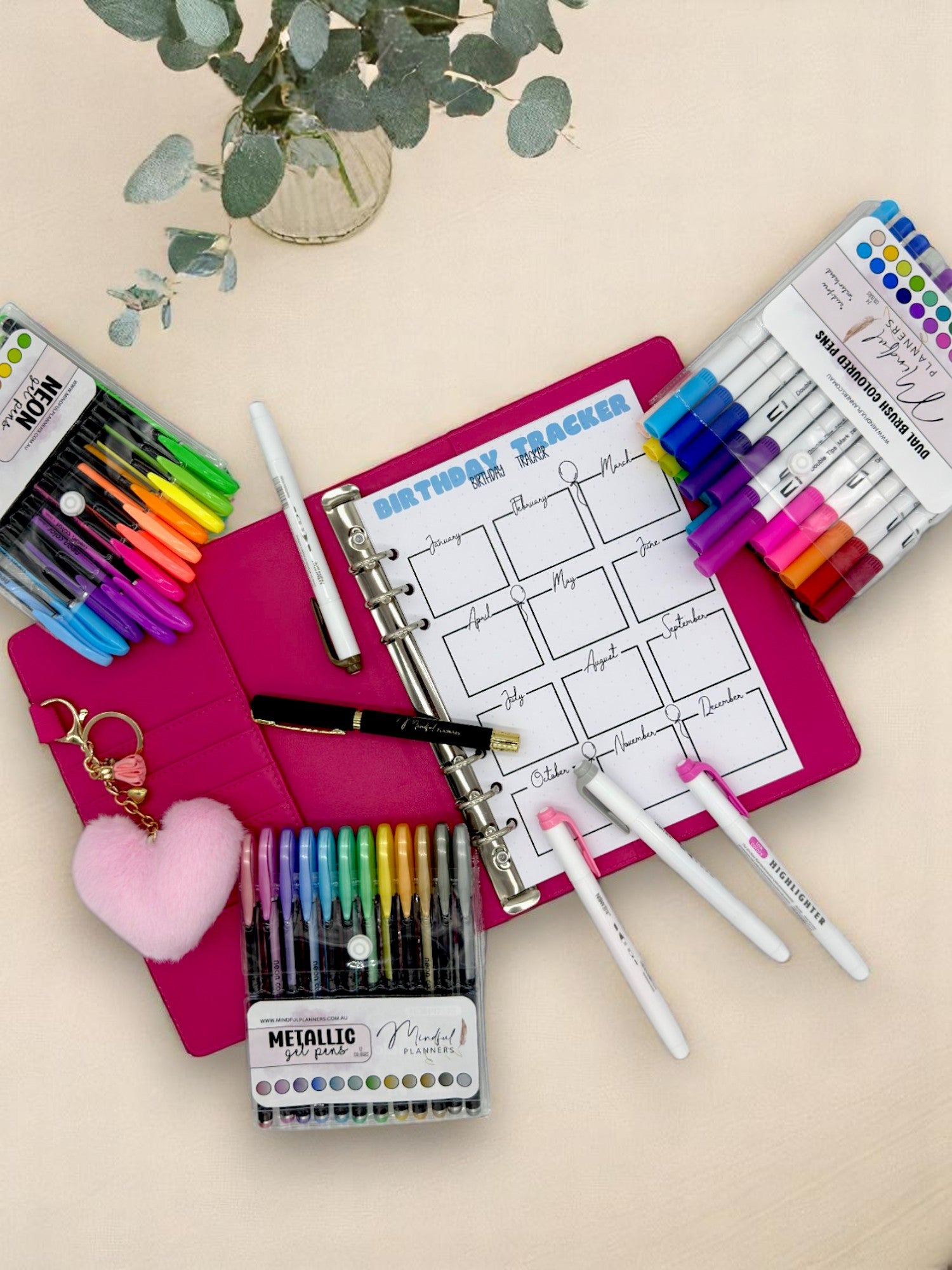 Journaling stationery such as dual brush pens and ballpoint pen on a table