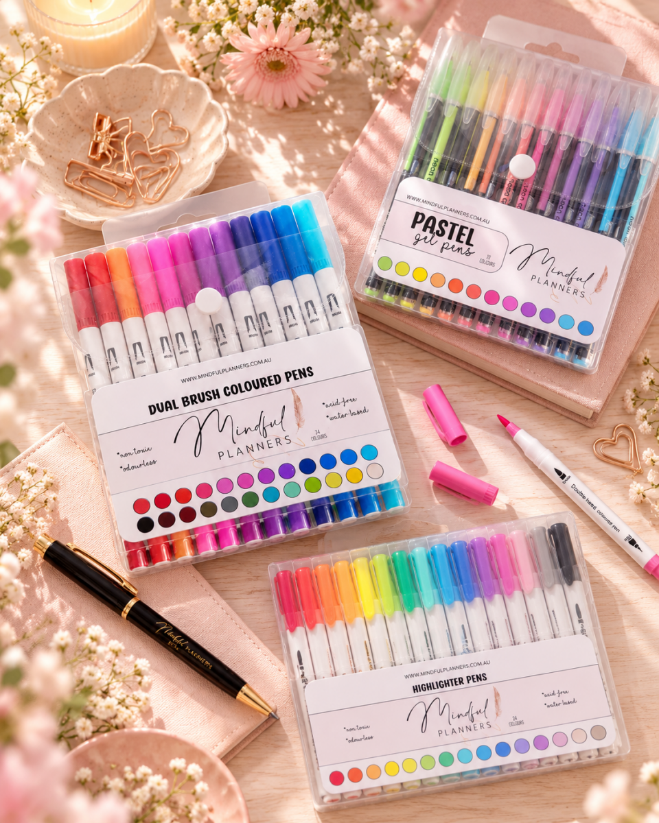 Highlighter pens and journaling accessories on a blush desk