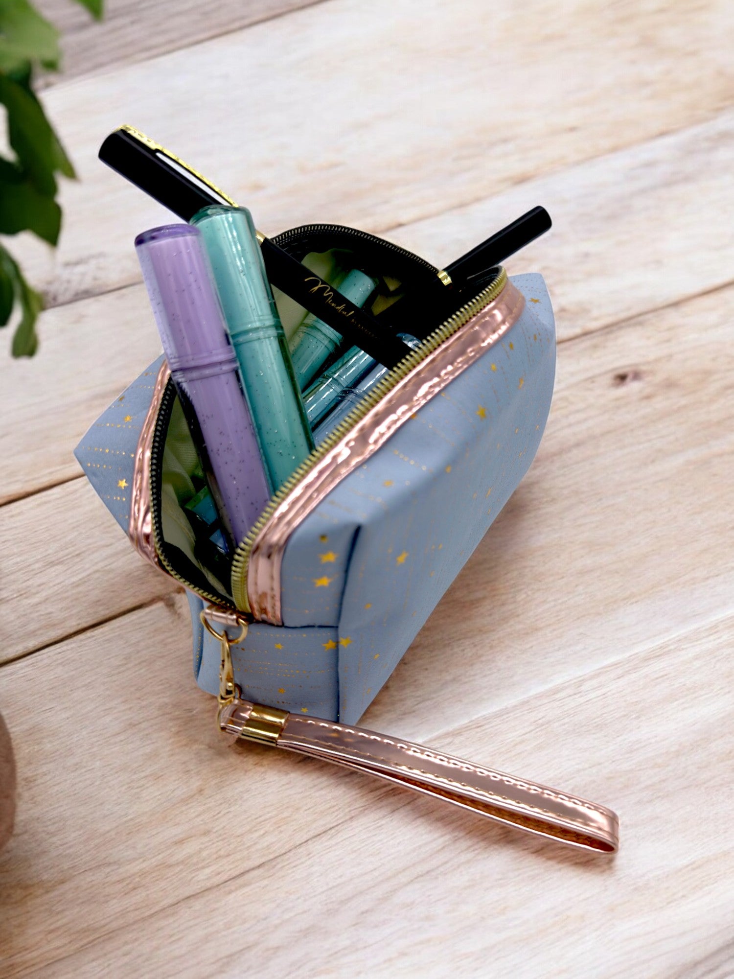 Markers and pens in a large blue sparkly pencil case