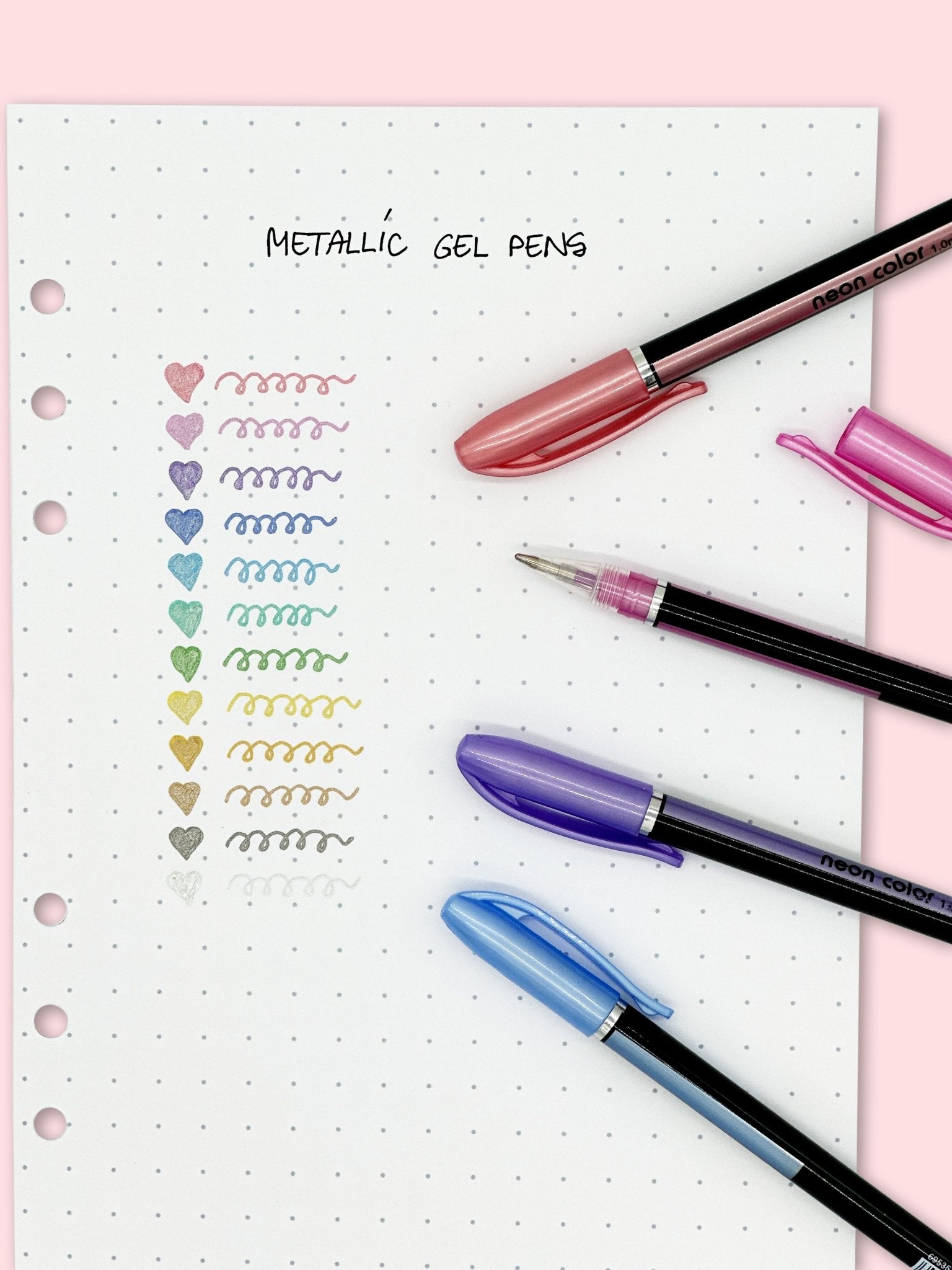 Metallic gel pens writing shiny ink on black bullet journal paper