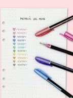 Metallic gel pens writing shiny ink on black bullet journal paper