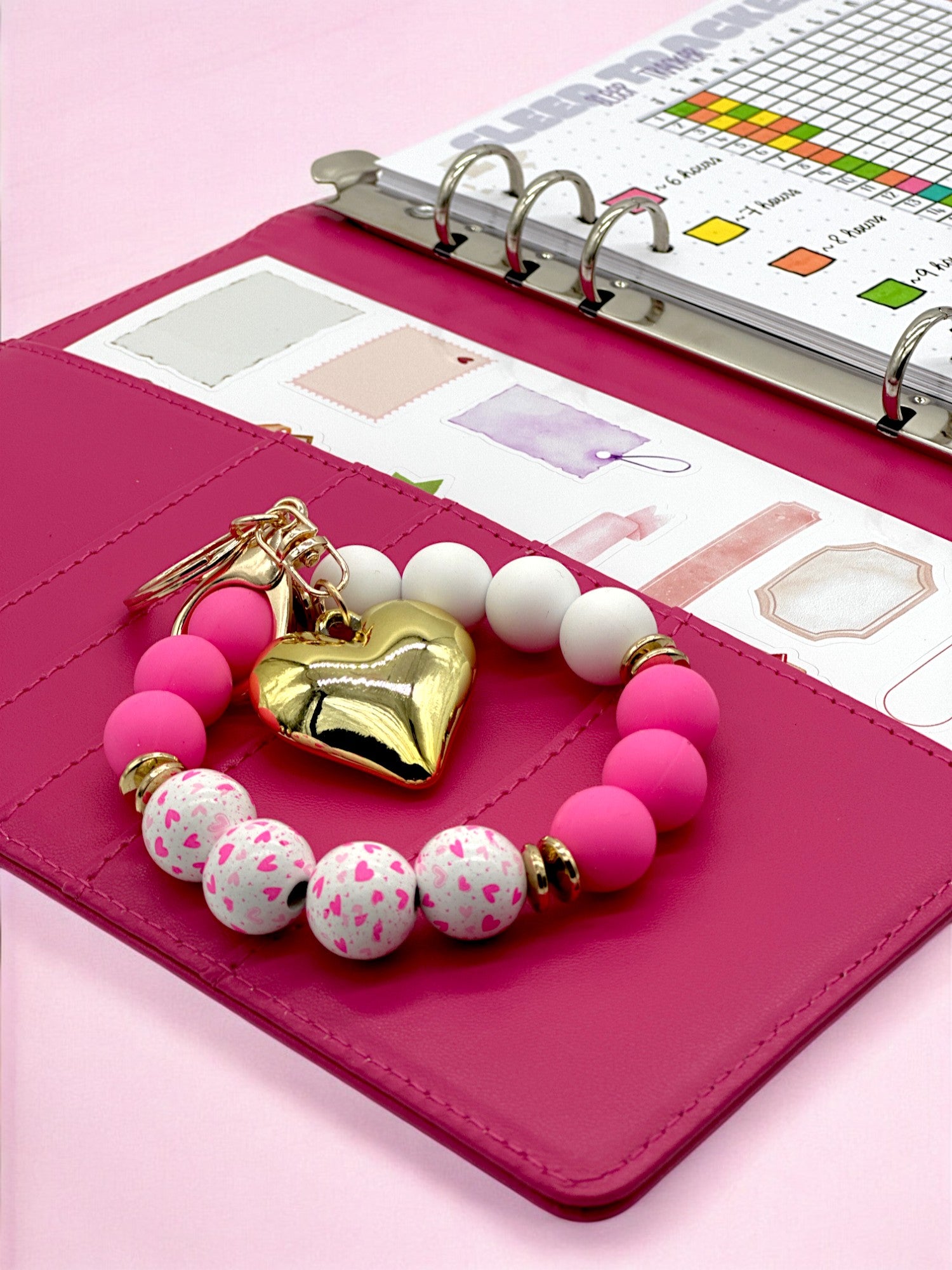 Neon pink beaded stretchy bracelet keychain in a fuschia pink bullet journal