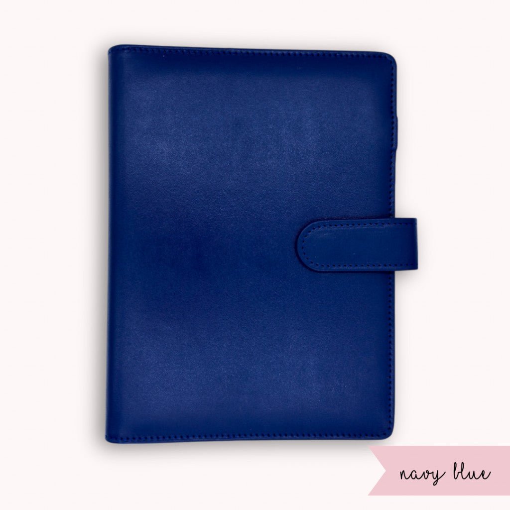 Navy blue planner cover with a strap on a white background